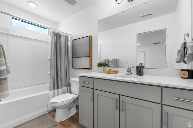 3814 S Landmark Ln Unit 1395, Magna, UT 84044 - bathroom featuring toilet, visible vents, shower / tub combo with curtain, wood finished floors, and vanity