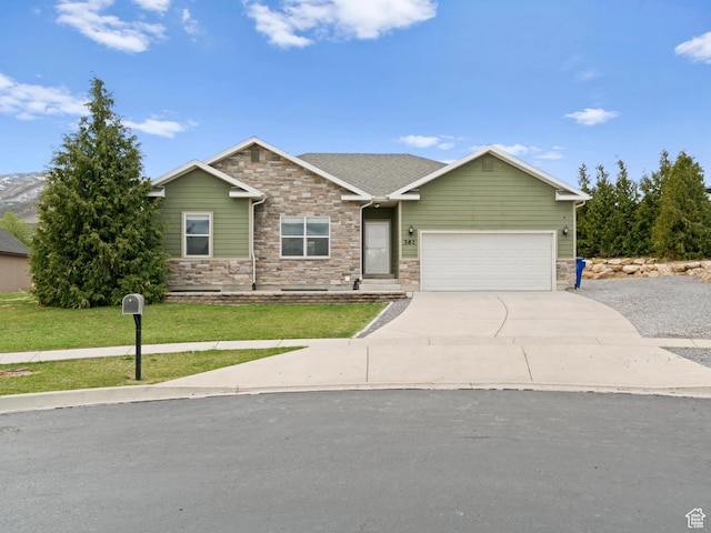 view of front of property with concrete driveway, an attached garage, stone siding, and a front yard