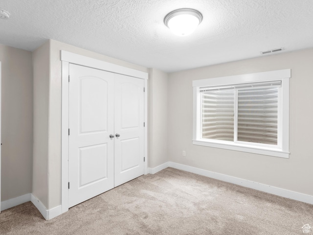 361 W Bridle Cir, Saratoga Springs, UT 84045 - unfurnished bedroom with a closet, a textured ceiling, carpet flooring, and baseboards