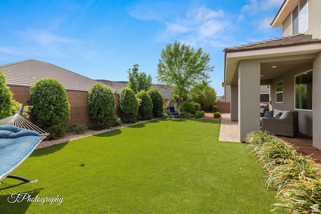 view of yard featuring outdoor lounge area, a patio area, and a fenced backyard