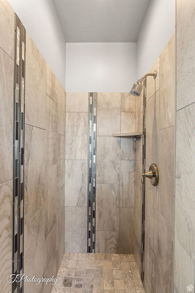 bathroom with a tile shower