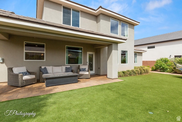 back of property with an outdoor living space, a patio area, a yard, and stucco siding