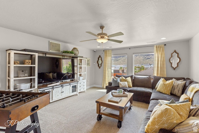 living room featuring light carpet, visible vents, and ceiling fan