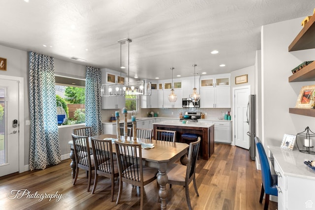dining area with dark wood-type flooring, visible vents, and recessed lighting