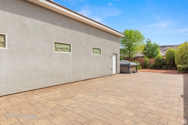 view of patio / terrace featuring a fenced backyard and a hot tub
