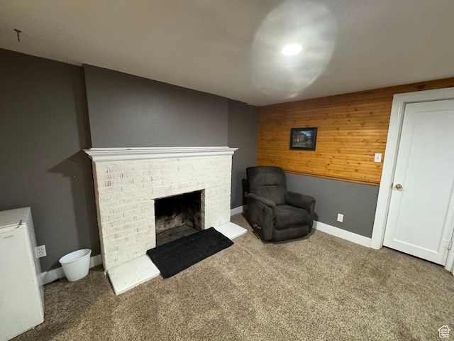 117 S 7th St, Montpelier, ID 83254 - sitting room featuring a fireplace, carpet flooring, wooden walls, and baseboards