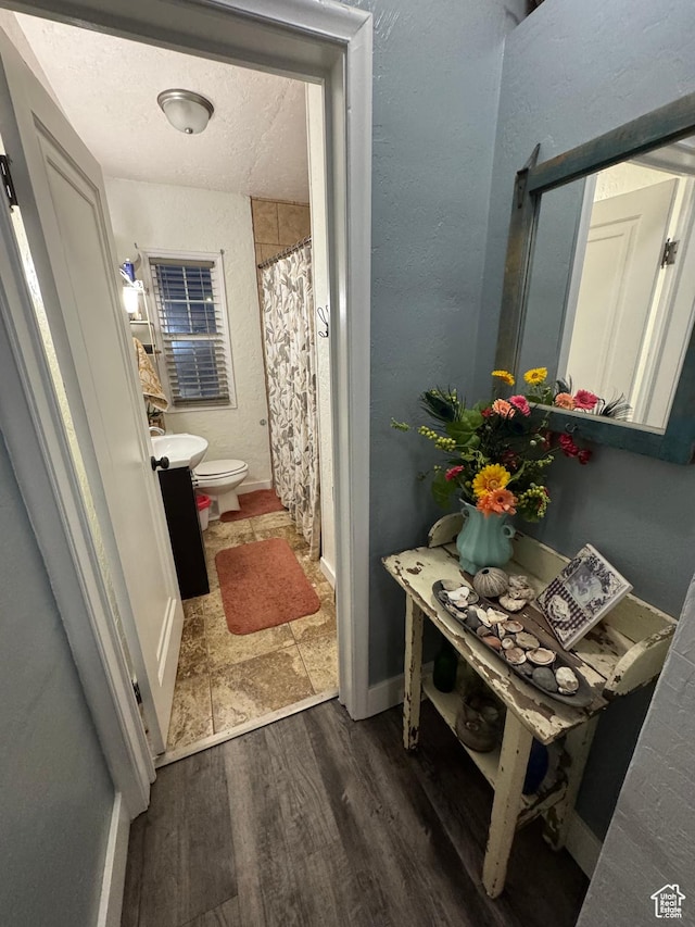 117 S 7th St, Montpelier, ID 83254 - full bathroom featuring toilet, wood finished floors, and baseboards