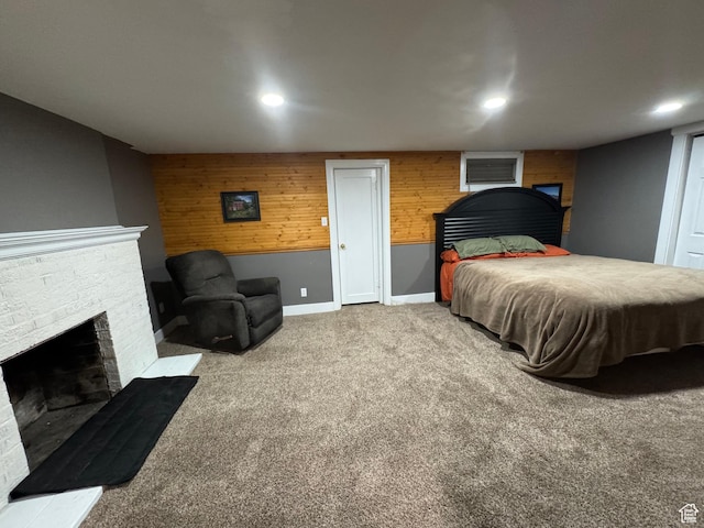 117 S 7th St, Montpelier, ID 83254 - bedroom featuring a fireplace with raised hearth, carpet flooring, wood walls, recessed lighting, and baseboards
