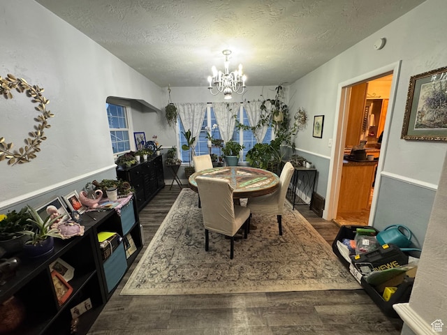 117 S 7th St, Montpelier, ID 83254 - dining space featuring wood finished floors, a chandelier, and a textured ceiling
