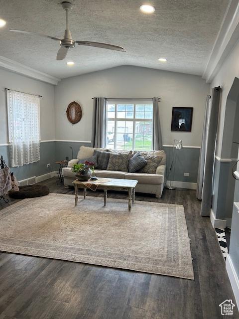 117 S 7th St, Montpelier, ID 83254 - living room featuring a textured ceiling, a ceiling fan, wood finished floors, vaulted ceiling, and baseboards