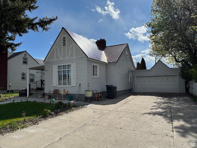 117 S 7th St, Montpelier, ID 83254 - rear view of house featuring metal roof, a chimney, and a garage