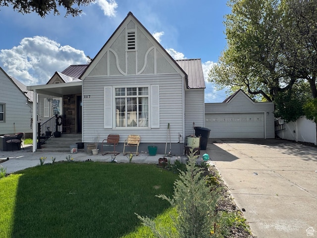 117 S 7th St, Montpelier, ID 83254 - view of front of home featuring metal roof, an outdoor structure, and a front lawn