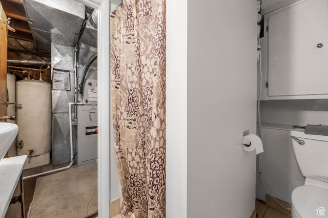 484 W 200 S, Tooele, UT 84074 - bathroom with gas water heater, a shower with shower curtain, and toilet