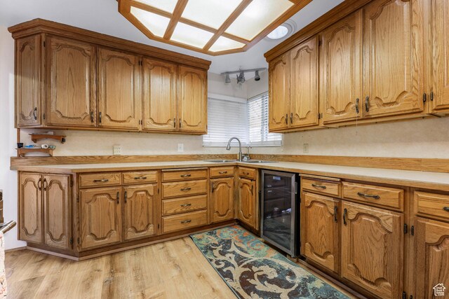 484 W 200 S, Tooele, UT 84074 - kitchen featuring light wood finished floors, wine cooler, a sink, brown cabinetry, and light countertops