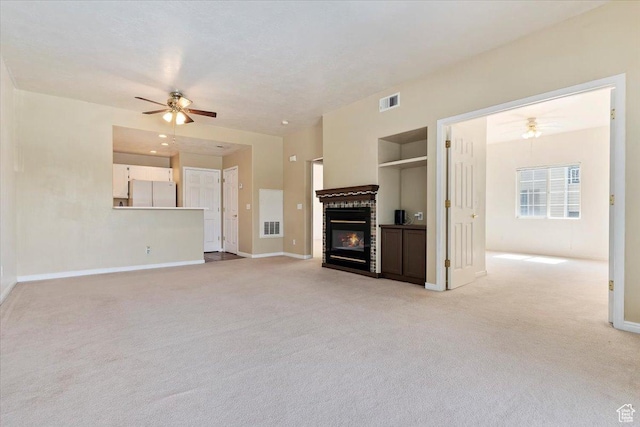 974 W Big River Ct Unit 2, South Salt Lake, UT 84119 - unfurnished living room with ceiling fan, light carpet, a brick fireplace, and visible vents