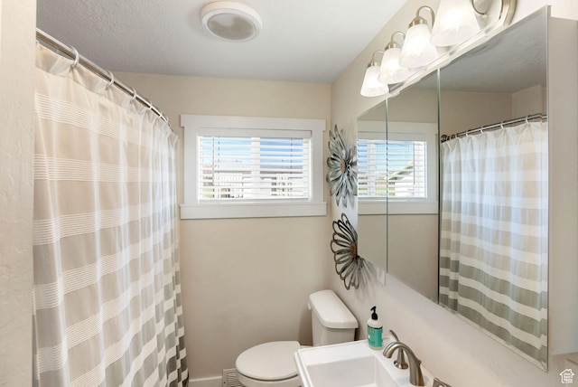 975 N 1400 W, Preston, ID 83263 - bathroom with toilet, a shower with curtain, a sink, and a healthy amount of sunlight
