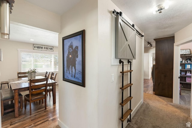975 N 1400 W, Preston, ID 83263 - corridor with a barn door, a textured ceiling, and baseboards