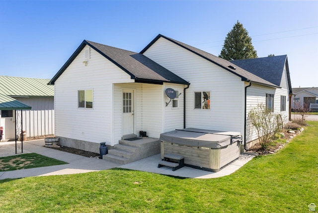 975 N 1400 W, Preston, ID 83263 - rear view of house featuring a hot tub, a yard, and a shingled roof
