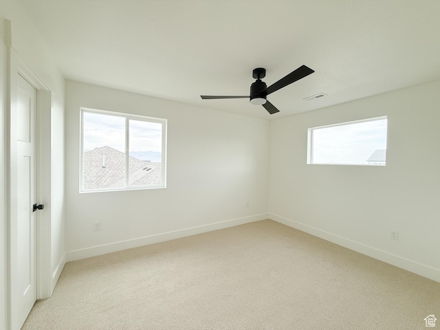 569 W 2030 N, Tooele, UT 84074 - spare room featuring light colored carpet, healthy amount of natural light, and a ceiling fan