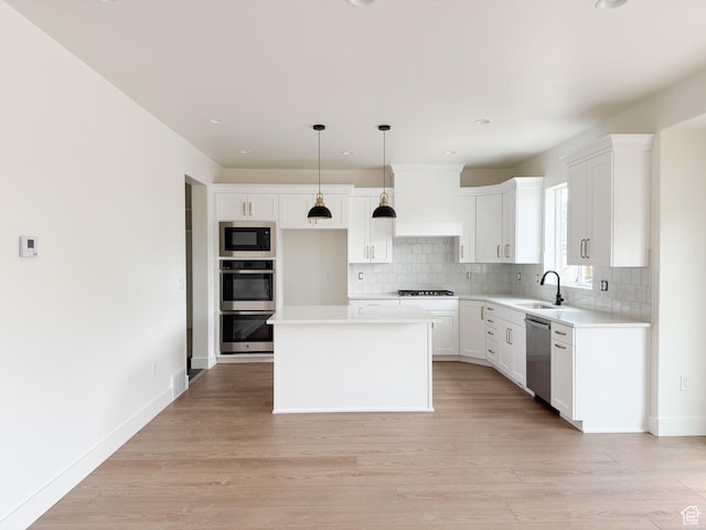 569 W 2030 N, Tooele, UT 84074 - kitchen with stainless steel appliances, custom exhaust hood, a center island, tasteful backsplash, and recessed lighting