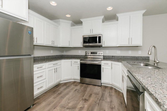 162 E 2480 N, North Logan, UT 84341 - kitchen featuring stainless steel appliances, a sink, white cabinetry, light stone countertops, and light wood-style floors