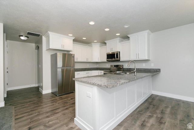 162 E 2480 N, North Logan, UT 84341 - kitchen featuring stainless steel appliances, a peninsula, baseboards, white cabinets, and recessed lighting