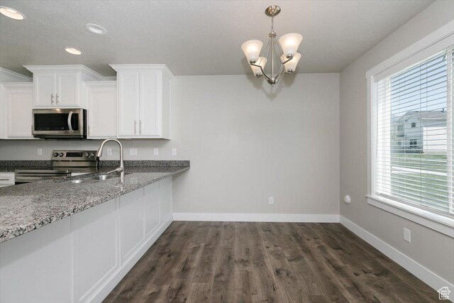 162 E 2480 N, North Logan, UT 84341 - kitchen with appliances with stainless steel finishes, healthy amount of natural light, baseboards, white cabinets, and recessed lighting