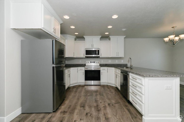 162 E 2480 N, North Logan, UT 84341 - kitchen with appliances with stainless steel finishes, a peninsula, a sink, white cabinetry, and recessed lighting