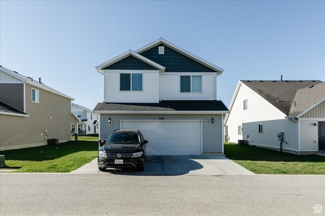 162 E 2480 N, North Logan, UT 84341 - view of front of property featuring central air condition unit, an attached garage, driveway, and a front yard