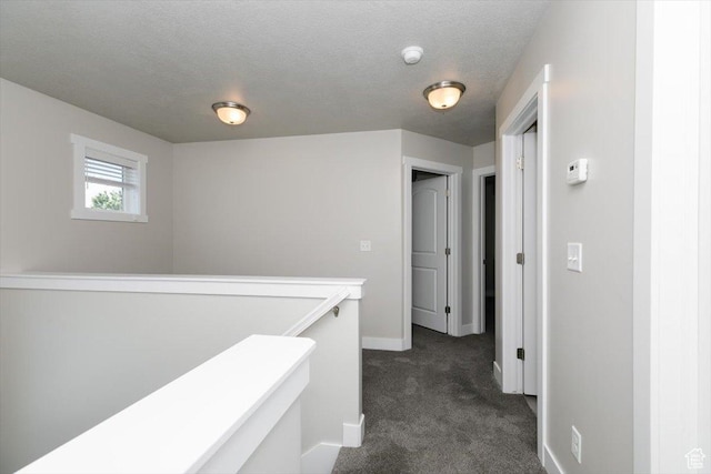 162 E 2480 N, North Logan, UT 84341 - hallway with dark carpet, an upstairs landing, and baseboards