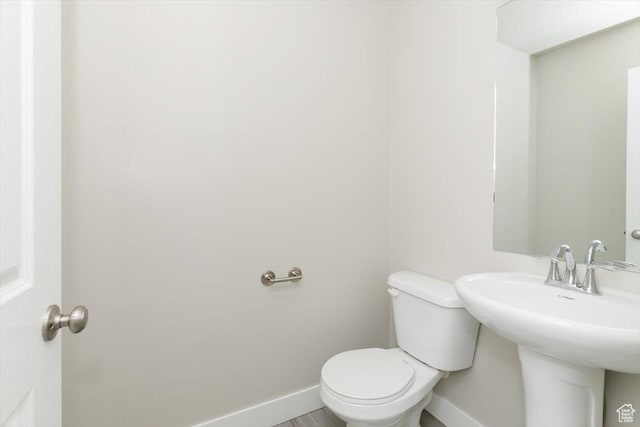 162 E 2480 N, North Logan, UT 84341 - bathroom with baseboards, toilet, and a sink