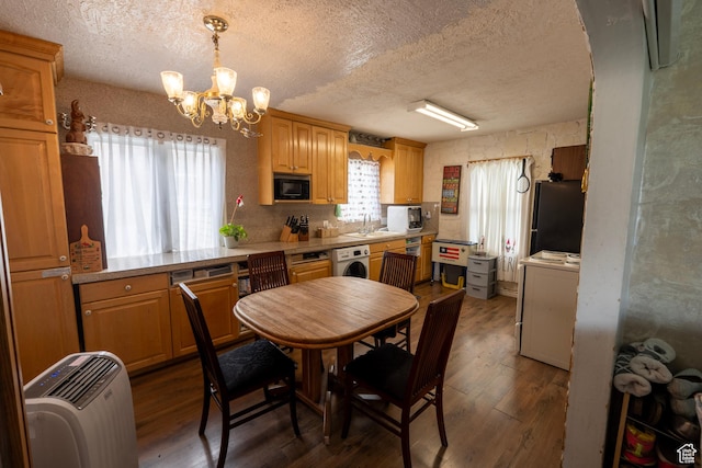 kitchen featuring black appliances, a chandelier, a textured ceiling, and a sink