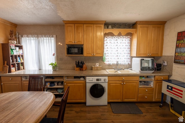 kitchen with a sink, a textured ceiling, black microwave, dark wood finished floors, and washer / clothes dryer