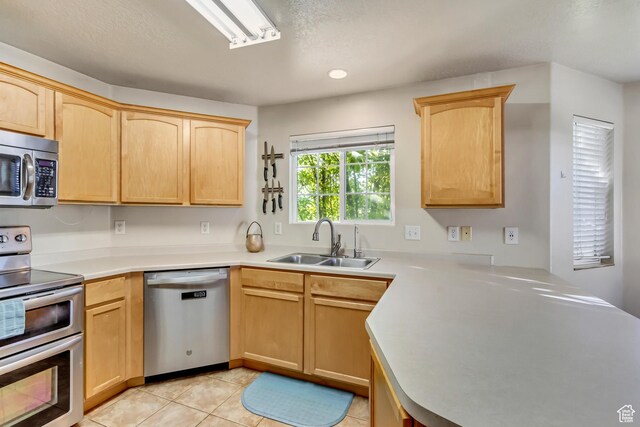 2093 N Morning Star Dr, Saratoga Springs, UT 84045 - kitchen with light brown cabinetry, stainless steel appliances, light countertops, and a sink