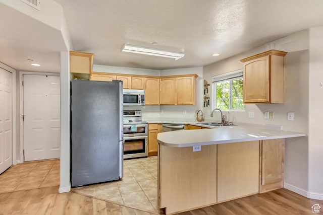 2093 N Morning Star Dr, Saratoga Springs, UT 84045 - kitchen featuring stainless steel appliances, light brown cabinets, a sink, and a peninsula