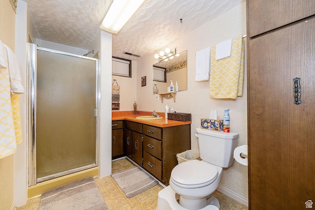 full bath featuring vanity, visible vents, toilet, a textured ceiling, and a shower stall
