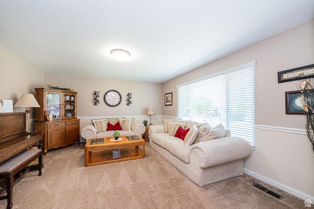 living room with baseboards, carpet flooring, and visible vents