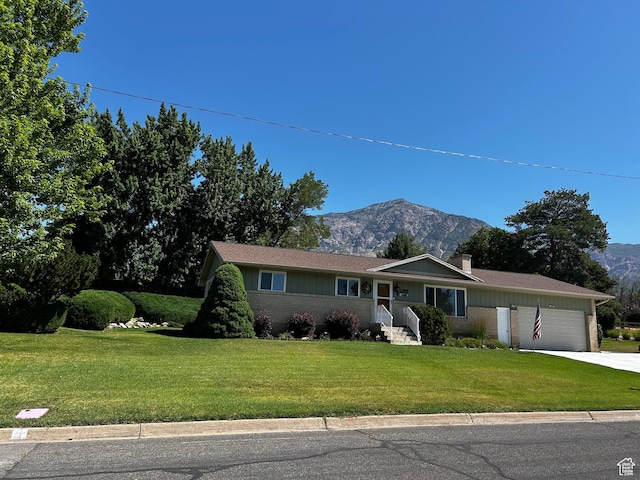 1026 W 3800 N, Pleasant View, UT 84414 - ranch-style house featuring a mountain view, a garage, a front yard, a chimney, and concrete driveway