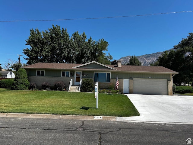 1026 W 3800 N, Pleasant View, UT 84414 - single story home with a chimney, brick siding, a garage, a front lawn, and driveway