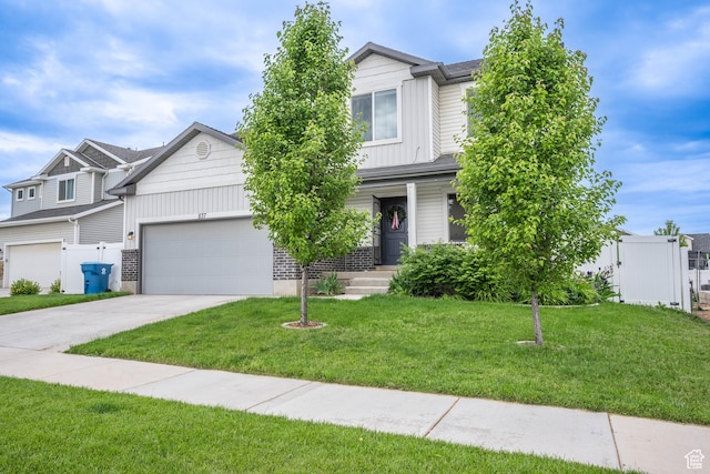 view of front of house featuring an attached garage, fence, driveway, and a front yard