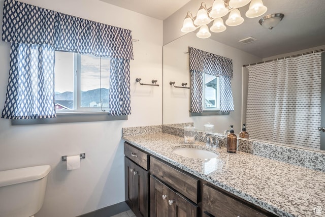 full bath with vanity, baseboards, toilet, a notable chandelier, and visible vents