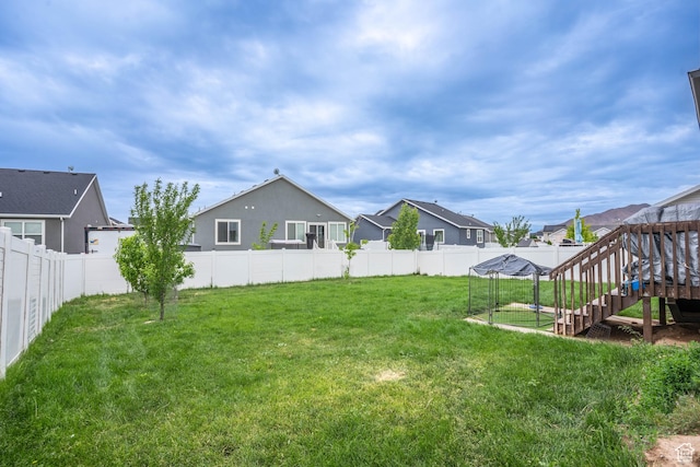 view of yard with a fenced backyard and a residential view