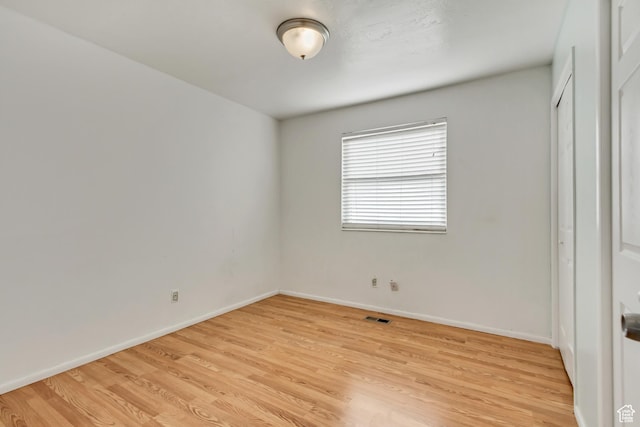 3916 S Hawkeye Dr, West Valley City, UT 84120 - unfurnished bedroom with baseboards, light wood finished floors, visible vents, and a closet