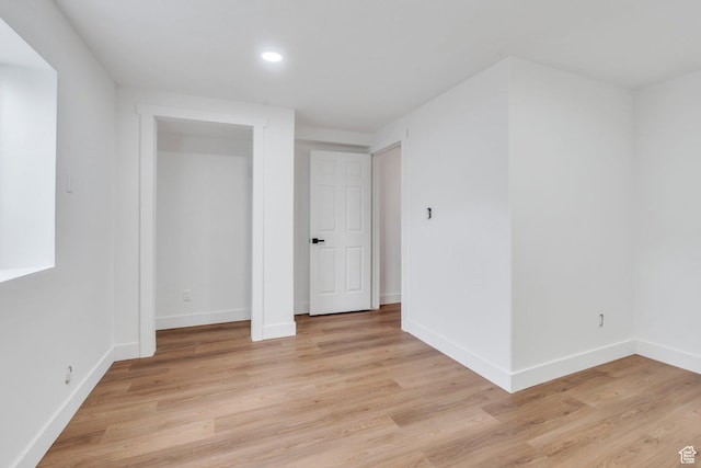 interior space featuring baseboards, recessed lighting, and light wood-style floors
