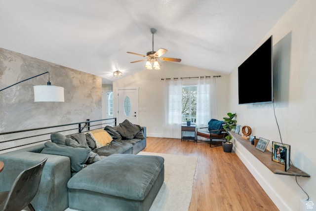 living room with vaulted ceiling, a ceiling fan, wood finished floors, and baseboards
