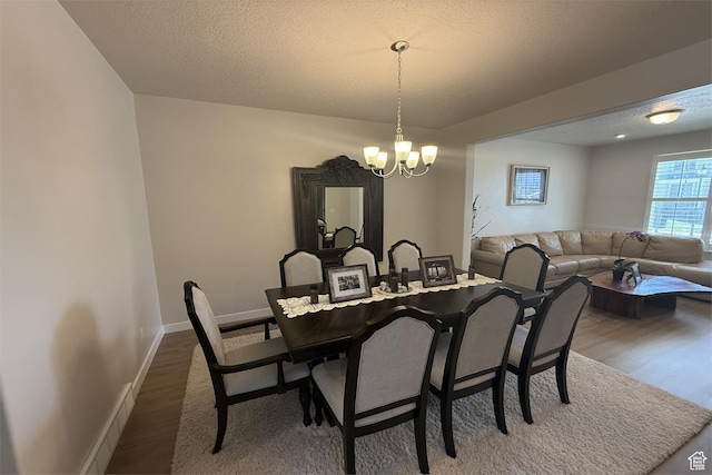 6129 W Coulee Ln, West Jordan, UT 84081 - dining area with baseboards, wood finished floors, a textured ceiling, and a chandelier