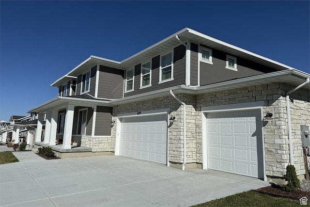 6129 W Coulee Ln, West Jordan, UT 84081 - view of front facade with a garage, stone siding, and concrete driveway