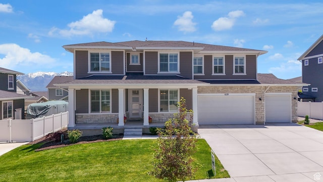 6129 W Coulee Ln, West Jordan, UT 84081 - view of front of home featuring covered porch, concrete driveway, stone siding, a garage, and an attached garage