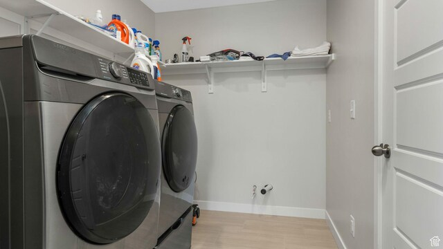 6129 W Coulee Ln, West Jordan, UT 84081 - laundry area with washer and dryer, light wood finished floors, and baseboards