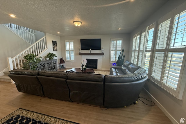 6129 W Coulee Ln, West Jordan, UT 84081 - living room with plenty of natural light, wood finished floors, baseboards, and a textured ceiling